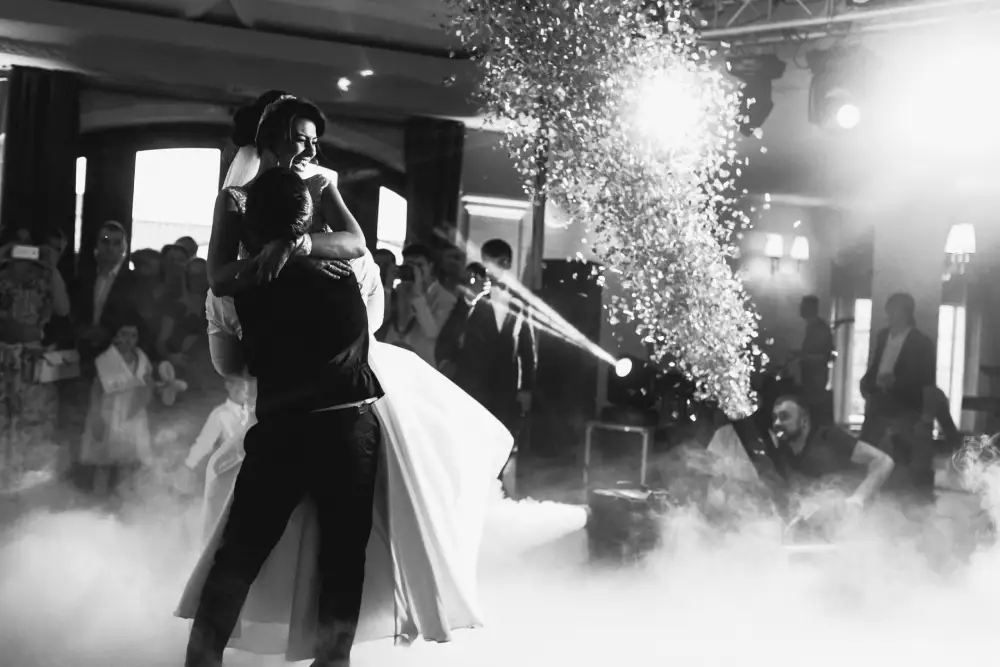 the groom kisses the bride while she is bent over on her back
